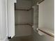 A pristine walk-in closet with white shelving and wooden rails for organized storage at 941 Olive Branch Dr, Smithfield, NC 27577