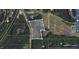 Aerial view of a property with boundaries outlined and surrounding wooded area and pond at 1917 New Hill Olive Chapel Rd, New Hill, NC 27562