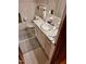 Bathroom with white tiled walls, tiled floor, and a vanity with round sink and white cabinets at 1917 New Hill Olive Chapel Rd, New Hill, NC 27562
