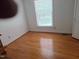 Bright bedroom with hardwood floors, a large window, and a closet for storage at 1917 New Hill Olive Chapel Rd, New Hill, NC 27562
