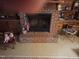 Interior view of a brick fireplace with hearth and wooden mantel and trim at 1917 New Hill Olive Chapel Rd, New Hill, NC 27562