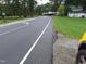 Street view of a road near a property with an open field and a house with an outbuilding at 1917 New Hill Olive Chapel Rd, New Hill, NC 27562