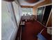 Bright sun room featuring paneled walls, large windows, and sliding glass door to outside at 1917 New Hill Olive Chapel Rd, New Hill, NC 27562