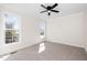 Spacious bedroom with neutral carpet, ceiling fan, and two large windows providing natural light at 195 N Smith St, Clayton, NC 27520