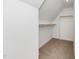 Carpeted closet with rods for hanging clothes, providing practical storage solutions in a well-lit space at 195 N Smith St, Clayton, NC 27520