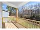 View of wood deck with railing overlooking the backyard and trees at 195 N Smith St, Clayton, NC 27520