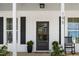 Inviting front door with glass pane and rocking chair on covered porch at 195 N Smith St, Clayton, NC 27520