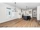 Open-concept kitchen featuring stainless steel appliances, island with seating, and modern lighting at 195 N Smith St, Clayton, NC 27520