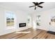 Cozy living room featuring a modern fireplace, wood floors, and large windows at 195 N Smith St, Clayton, NC 27520