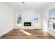 Bright and airy living room with modern fireplace, beautiful hardwood floors and natural light at 195 N Smith St, Clayton, NC 27520