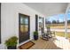 Cozy front porch featuring rocking chairs, plants and paneled ceiling at 195 N Smith St, Clayton, NC 27520