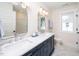 Beautiful bathroom featuring a double vanity with granite counters, stylish mirror and ample lighting at 199 N Smith St, Clayton, NC 27520