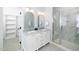 Elegant bathroom featuring a double vanity, framed mirrors and a glass-enclosed shower with marble surround at 199 N Smith St, Clayton, NC 27520