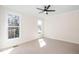 Bright bedroom with two windows and neutral carpet, complemented by a modern ceiling fan at 199 N Smith St, Clayton, NC 27520