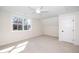 Bright bedroom with neutral carpet and a window offering views of the surrounding greenery at 199 N Smith St, Clayton, NC 27520
