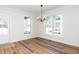 Light-filled dining room featuring wood floors and a modern chandelier at 199 N Smith St, Clayton, NC 27520