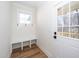 Charming entryway featuring a built-in bench with coat hooks and a stylish wood-look floor at 199 N Smith St, Clayton, NC 27520
