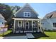 Attractive gray home with a covered front porch and an American flag at 199 N Smith St, Clayton, NC 27520