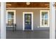 Charming front porch with blue door, neutral siding, and inviting bench at 199 N Smith St, Clayton, NC 27520