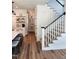 Bright hallway and staircase with white trim and hardwood floors, leading from the kitchen at 199 N Smith St, Clayton, NC 27520