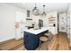 Bright kitchen features a large island with seating, pendant lighting, and stainless steel appliances at 199 N Smith St, Clayton, NC 27520