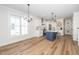 Open kitchen and dining area featuring stainless appliances, a blue island, and hardwood floors at 199 N Smith St, Clayton, NC 27520