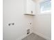 Functional laundry room area with cabinetry and tiled floor, providing a clean and efficient space at 199 N Smith St, Clayton, NC 27520