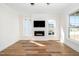 Bright living room with a fireplace, flat screen TV, hardwood floors, and natural light at 199 N Smith St, Clayton, NC 27520