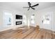Bright living room with modern fireplace, large windows, and wood floors at 199 N Smith St, Clayton, NC 27520