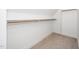 Bright, empty walk-in closet with a wooden clothes bar, and carpet at 199 N Smith St, Clayton, NC 27520