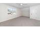 Spacious bedroom with plush carpeting, natural light, and a ceiling fan at 201 N Smith St, Clayton, NC 27520