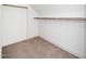 A closet with carpeting and wood shelving to maximize storage space at 201 N Smith St, Clayton, NC 27520