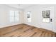 Bright dining room with wood floors, white walls, chandelier and a white door with glass at 201 N Smith St, Clayton, NC 27520