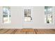 Welcoming entryway with hardwood floors, large windows, and a stylish front door at 201 N Smith St, Clayton, NC 27520
