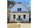 Inviting two-story home featuring a covered porch and well-maintained landscaping at 201 N Smith St, Clayton, NC 27520