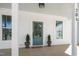 Inviting front porch with a teal door, white columns, and craftsman-style details at 201 N Smith St, Clayton, NC 27520