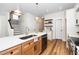 Open kitchen with a large island, stainless steel dishwasher, and modern lighting at 201 N Smith St, Clayton, NC 27520