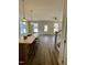 Open concept layout from kitchen with a large island into living space with a fireplace at 201 N Smith St, Clayton, NC 27520