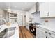 Kitchen with stainless steel appliances, modern lighting, and tiled backsplash at 201 N Smith St, Clayton, NC 27520