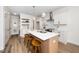 Open concept kitchen features an island with seating and modern lighting at 201 N Smith St, Clayton, NC 27520
