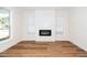 Spacious living room featuring a modern fireplace, large windows, and wood flooring at 201 N Smith St, Clayton, NC 27520