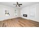 Cozy living room features a modern fireplace with a fan and beautiful hardwood floors at 201 N Smith St, Clayton, NC 27520