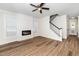 Open-concept living area with fireplace, staircase, and abundant natural light at 201 N Smith St, Clayton, NC 27520