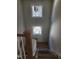Staircase featuring hardwood steps and railings, illuminated by natural light from windows at 201 N Smith St, Clayton, NC 27520