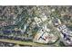 An aerial view shows a residential area with streets, trees, and nearby commercial establishments and community resources at 725 Catawba St, Raleigh, NC 27609