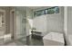 Contemporary bathroom featuring a walk-in shower, soaking tub, modern fixtures, and sleek design at 725 Catawba St, Raleigh, NC 27609