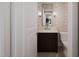 Cozy powder room with a modern vanity, decorative mirror, and neutral color palette at 725 Catawba St, Raleigh, NC 27609