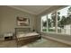 Modern bedroom with a minimalist design, a large window, and neutral color palette at 725 Catawba St, Raleigh, NC 27609