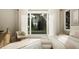 Cozy bedroom with a large window and decorative artwork. Features neutral decor, a sitting chair and side table at 725 Catawba St, Raleigh, NC 27609