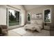The light-filled bedroom features neutral tones, large windows with forest views, and stylish decor at 725 Catawba St, Raleigh, NC 27609